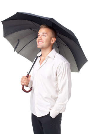 Happy young man under an umbrella isolated on white backgroundの写真素材
