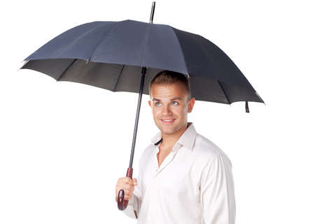Happy young man under an umbrella isolated on white backgroundの写真素材