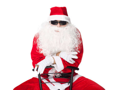 Santa Claus wearing sunglasses and smoking a cigar isolated on white backgroundの写真素材