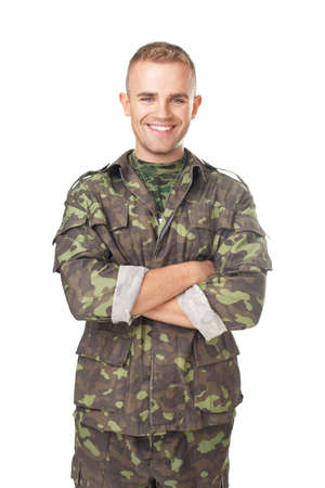 Smiling army soldier with his arms crossed isolated on white backgroundの写真素材