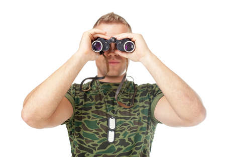 Young army soldier looking through binoculars isolated on white backgroundの写真素材