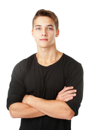 Portrait of young man standing with hands folded against isolated on white backgroundの写真素材