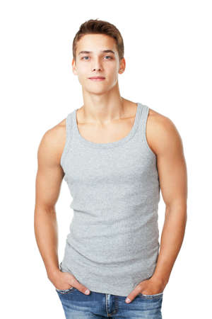 Portrait of young man wearing t-shirt standing with hands in pockets isolated on white backgroundの写真素材