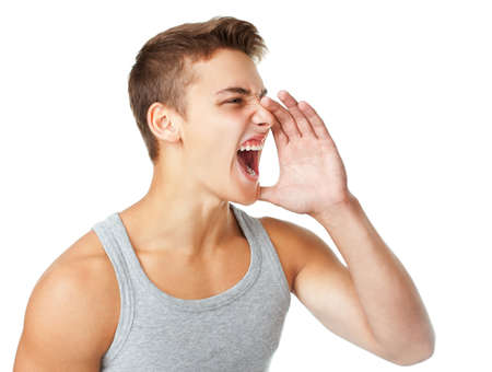 Young man wearing T-shirt shouting isolated on white backgroundの写真素材