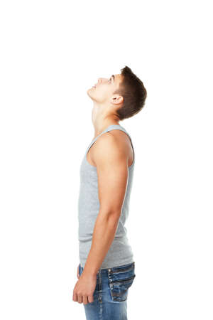 side view portrait of young man looking up isolated on white backgroundの写真素材