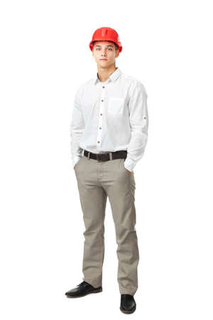 Full length portrait of young engineer wearing a red helmet isolated on white backgroundの写真素材