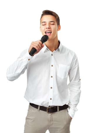 Young man singing into a microphone isolated on white backgroundの写真素材