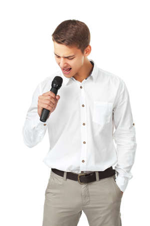 Young man singing into a microphone isolated on white backgroundの写真素材