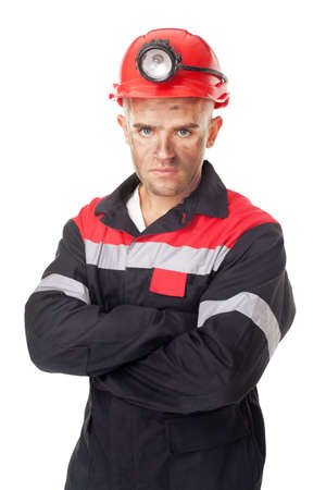 Portrait of serious coal miner with his arms crossed isolated on white backgroundの写真素材