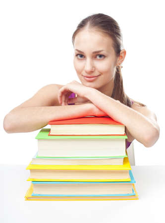 Portrait of pretty young happy smiling student girl with pile of books isolated on white backgroundの写真素材