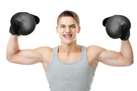 Portrait of angry young boxer showing biceps isolated on white backgroundの写真素材