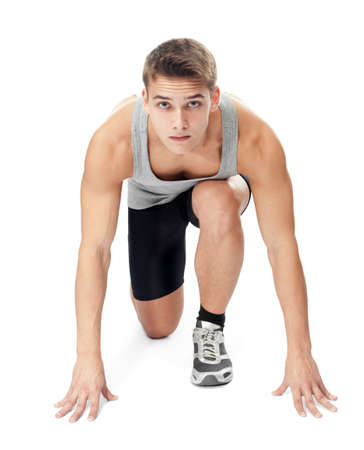 Full length portrait of athlete man ready to run, looking at camera isolated on white backgroundの写真素材