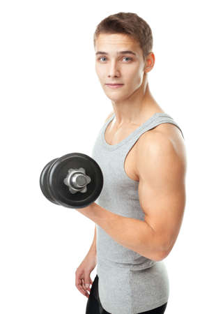Portrait of young man bodybuilder exercising with dumbbells for training his biceps isolated on white backgroundの写真素材