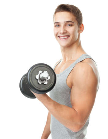 Portrait of smiling young fit muscular man exercising with dumbbells for training his biceps isolated on white backgroundの写真素材