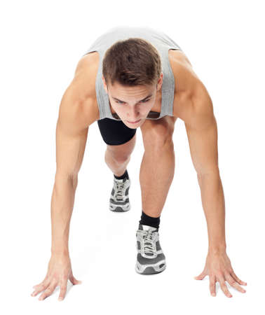 Full length portrait of athlete man ready to run isolated on white backgroundの写真素材