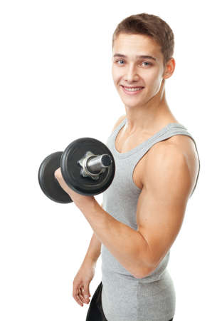 Portrait of smiling young man bodybuilder exercising with dumbbells for training his biceps isolated on white backgroundの写真素材