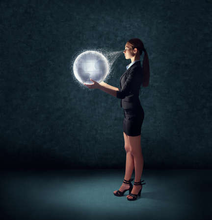 business woman holding glowing planet earth の写真素材