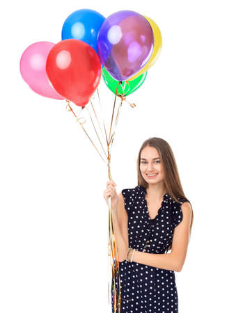 Portrait of beautiful young happy woman in polka dot dress with colorful balloons isolated on white backgroundの写真素材