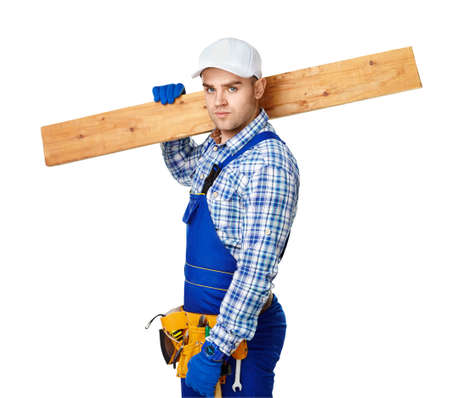 Portrait of young carpenter carrying wooden plank over his shoulder isolated on white backgroundの写真素材