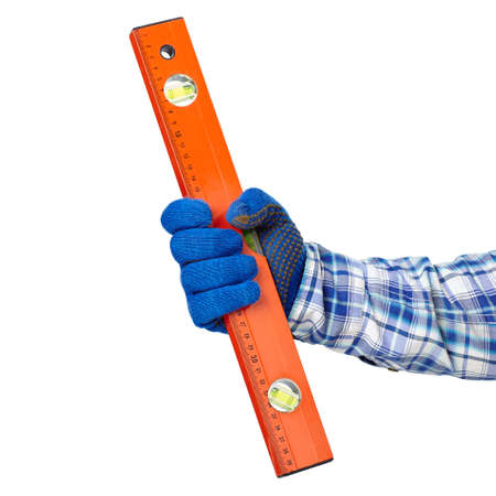 Working hand with protection glove holding spirit level isolated on white backgroundの写真素材