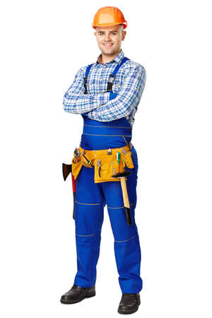 Full length portrait of young male construction worker wearing protective clothes, helmet and tool belt isolated on white backgroundの写真素材