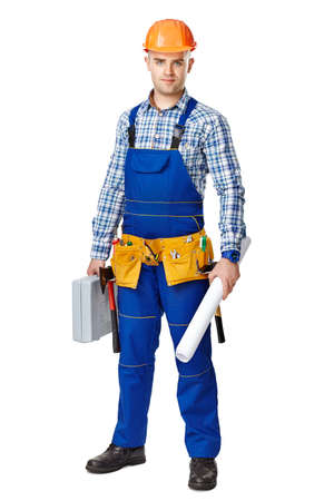 Full length portrait of young male construction worker with toolbox and drawings, wearing protective clothes, helmet and tool belt isolated on white backgroundの写真素材