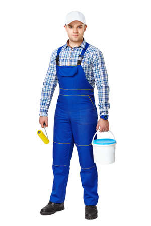Full length portrait of young painter with paint and brush ready to work isolated on white backgroundの写真素材