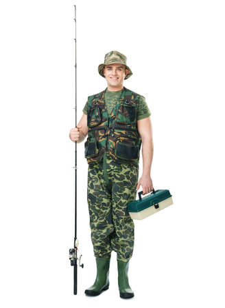 Full length portrait of a young smiling fisherman in camouflage holding a fishing equipment isolated on white backgroundの写真素材