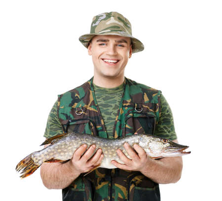 Portrait of a young happy laughing fisherman with his catch isolated on white backgroundの写真素材