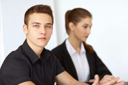 Portrait of two beautiful young businesspeople on white backgroundの写真素材