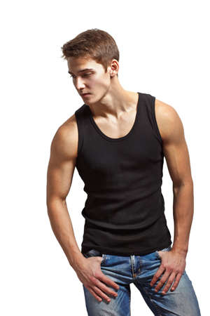 Portrait of young stylish man wearing undershirt and jeans isolated on white backgroundの写真素材