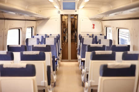 Interior of a passenger train with empty seats