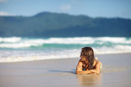 beautiful woman relaxing on a beachの写真素材