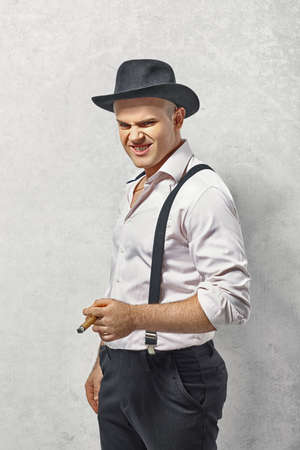 Dangerous man in gangster clothing with cigarの写真素材