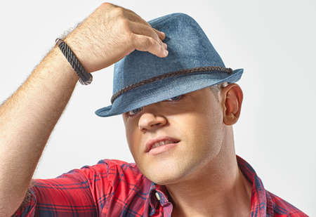 Portrait of young attractive man wearing a hatの写真素材