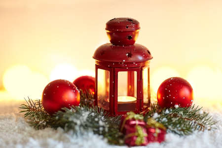 Christmas background with fir tree and lantern in snow