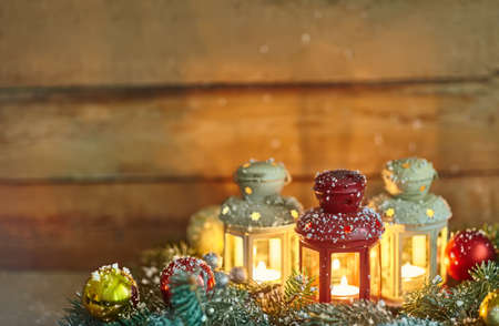 Christmas background composition with lanterns, baubles and fir in snowの写真素材