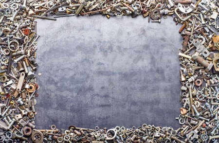 assorted screw nuts and bolts frame on metal texture backgroundの写真素材
