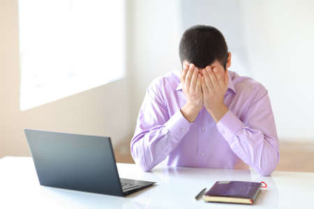 Tired businessman in officeの写真素材
