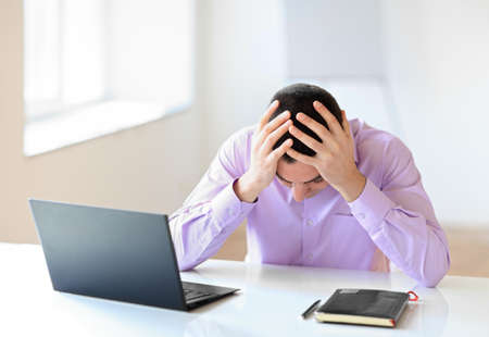 Portrait of stressful tired businessman at workの写真素材
