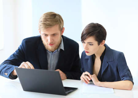 Business people discussing ideas at meeting using laptop in the officeの写真素材