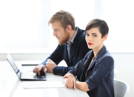 Businesswoman and businessman working together in the officeの写真素材