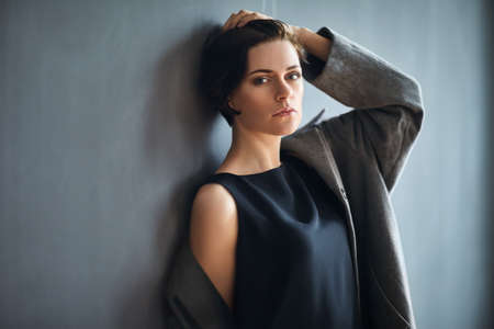 Portrait of fashion beautiful woman on dark backgroundの写真素材