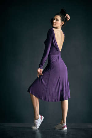 Latino dancer girl posing on dark backgroundの写真素材
