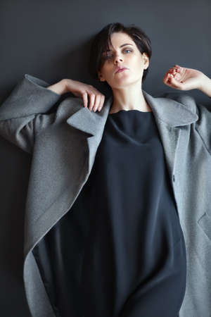 fashion lonely girl in motion posing on dark backgroundの写真素材
