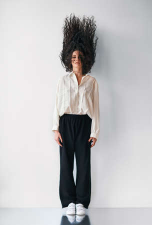 motionless fashion woman with flying hair upの写真素材