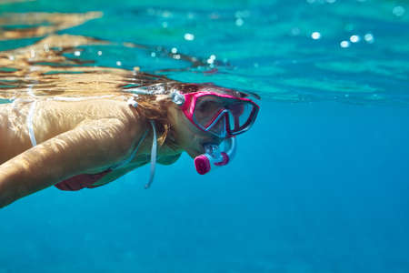 underwater portrait of young lady snorkeling in mask. vacation conceptの写真素材