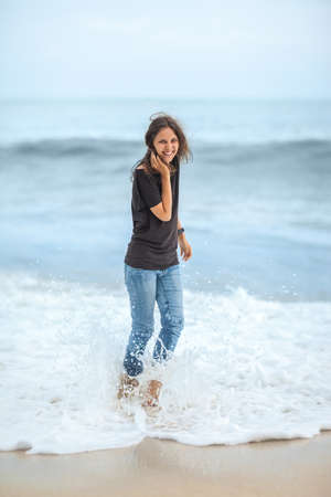 happy beautiful woman enjoying the waves on the tropical sea. Beach fun