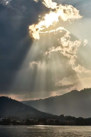 dramatic sky with sun rays over the sea. Nature backgroundの写真素材