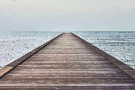 Perspective view of a wooden pier in a tropical seaの写真素材